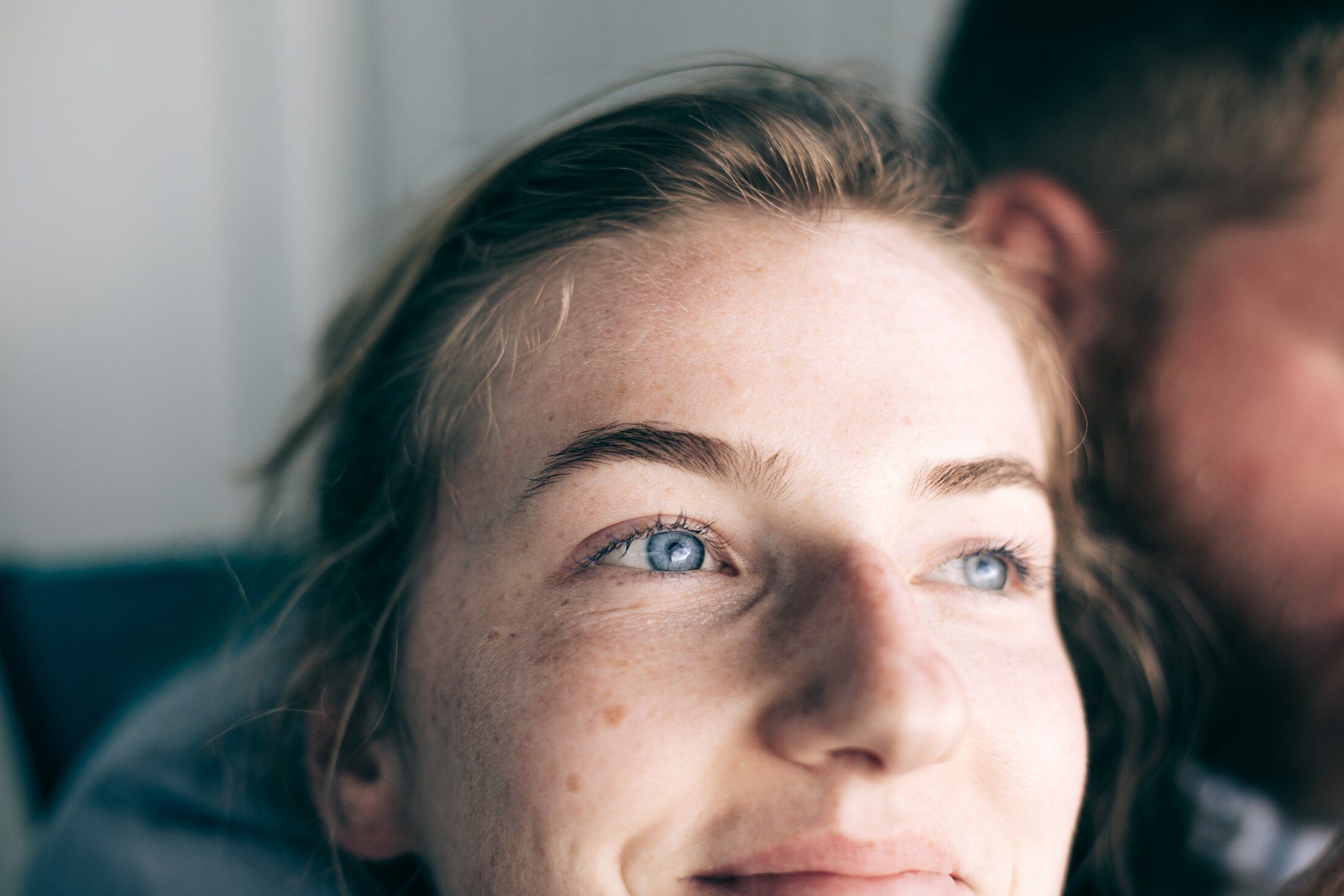 A close editorial portrait with direct eye contact