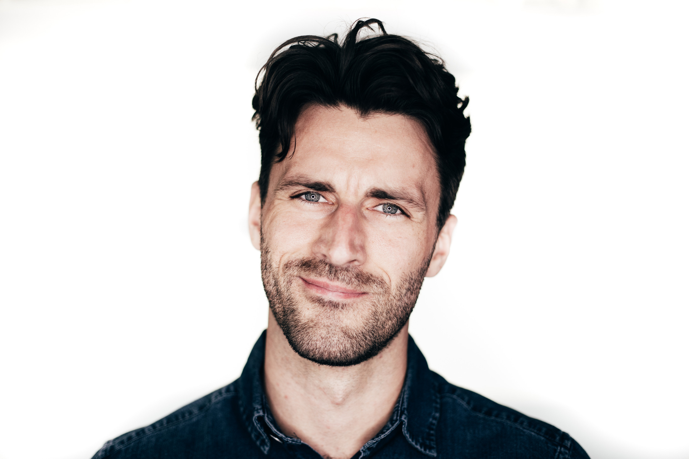 A clean professional headshot against a bright white background
